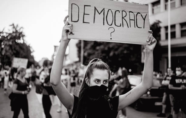 istock Young woman protester holding placard 1262680165