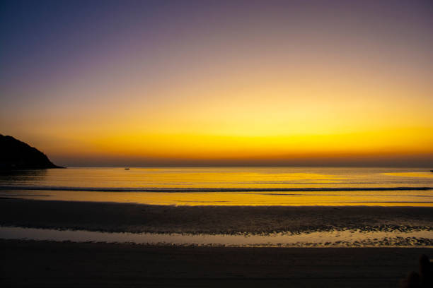 istock Colorful sea beach sunrise with deep blue sky and sun rays. 1262681253