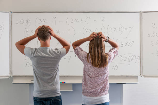 istock confused high school students in front of whiteboard 1262682046