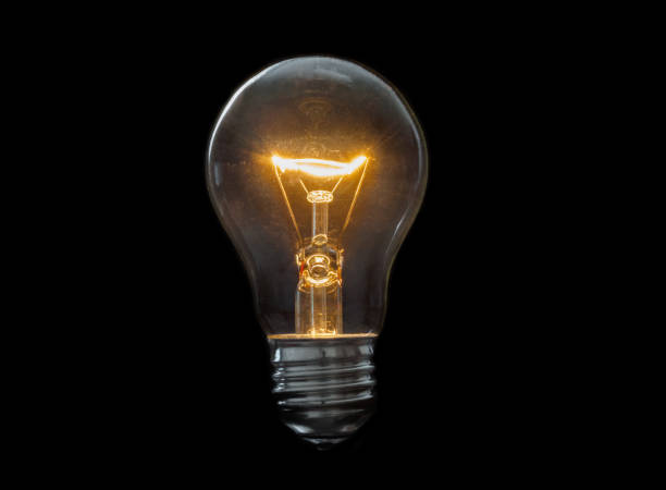 istock Old, dirty light bulb close up on black background 1262682275