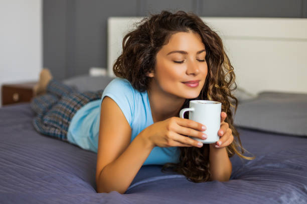 istock Woman  drinking coffee in her bed 1262684117