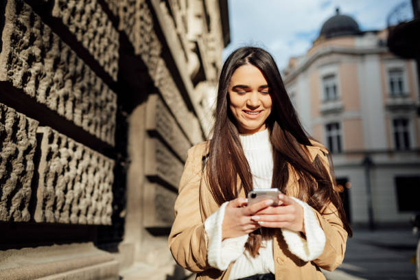 istock Front view of a happy Caucasian woman using a smart phone 1262686219