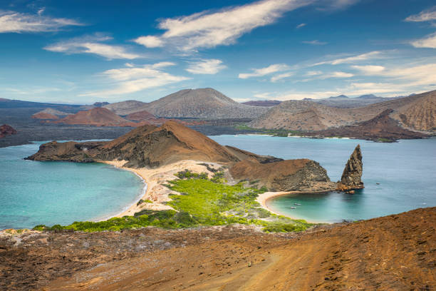 Aerial view of Pinnacle Rock, Bartolome Island, Galapagos, Ecuador Aerial view of the famous Pinnacle Rock on the small island of Bartolome, Galapagos, Ecuador. In the background is Santiago island. isla san salvador stock pictures, royalty-free photos & images