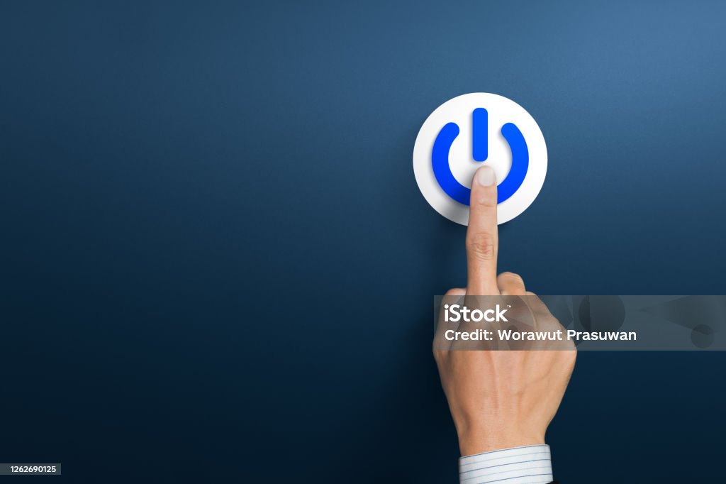 Hand of the businessman pressing power button. Start up business concept Restarting Stock Photo