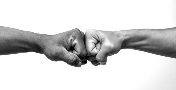 Man giving fist bump, monochrome, black and white image. stock photo