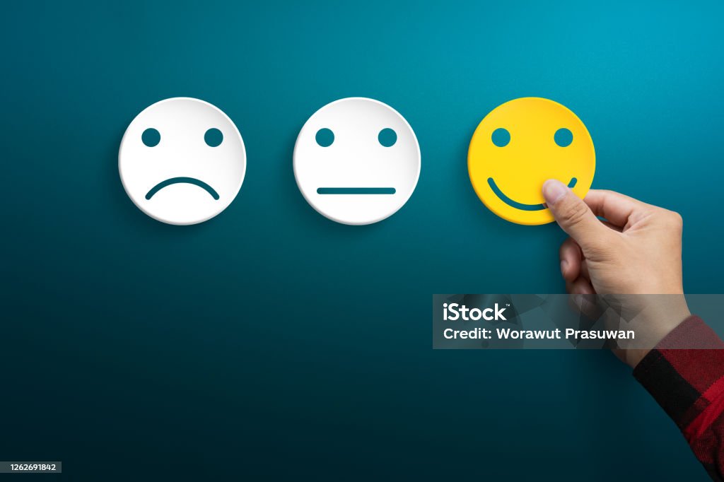Customer service experience and satisfaction survey concepts. The client's hand picked the happy face smile face. Feedback Stock Photo