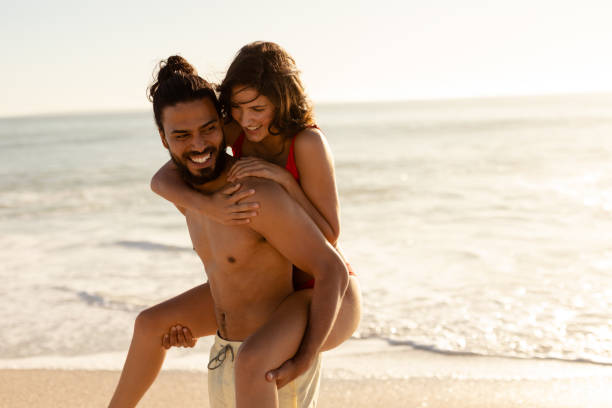 istock Multi-ethnic couple having fun on the beach 1262692020