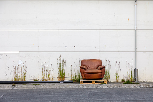Armchair left outside a factory at the harbor of Husavik – probably somebody wanted to sit an enjoy the sparse sun