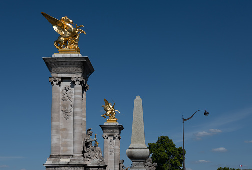 Historic 19th century gilded statues on Pont Alexandre III bridge in Paris