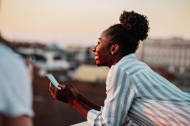 istock African American woman using mobile phone and relaxing 1262697717
