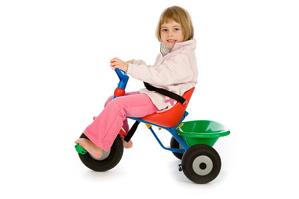 istock Small girl on colored toy trike on white 126269974