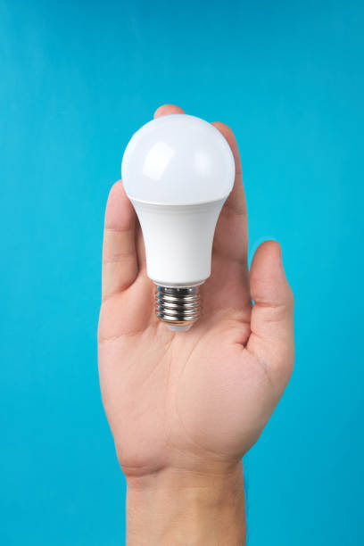 istock male person holding white led light bulb. electricity technologies. idea and solution conceptual 1262704575