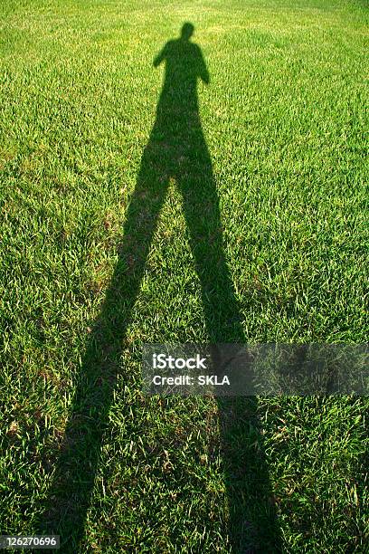 Tall Shadow Man Shadow On Green Grass Stock Photo - Download Image Now - Abstract, Adult, Adults Only