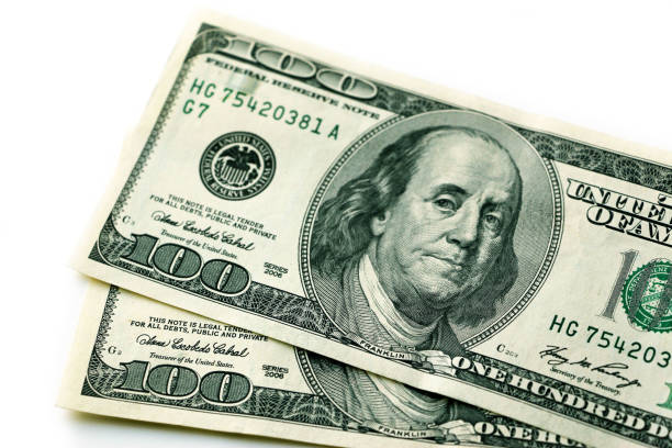 istock One hundred paper dollars on a white background isolated. 1262716107