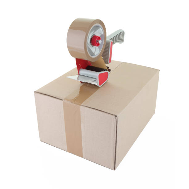 istock Tape gun and cardboard box on white with clipping path 1262718243