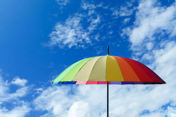 Colorful umbrella multicolored on a blue sky background