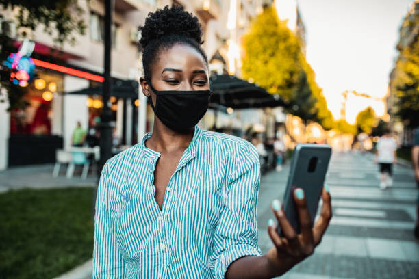 istock Woman with a mask taking a selfie 1262727863
