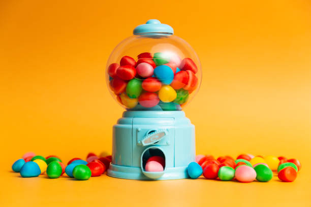 istock candy machine with jelly beans, multicoloured jelly beans, orange background 1262729180
