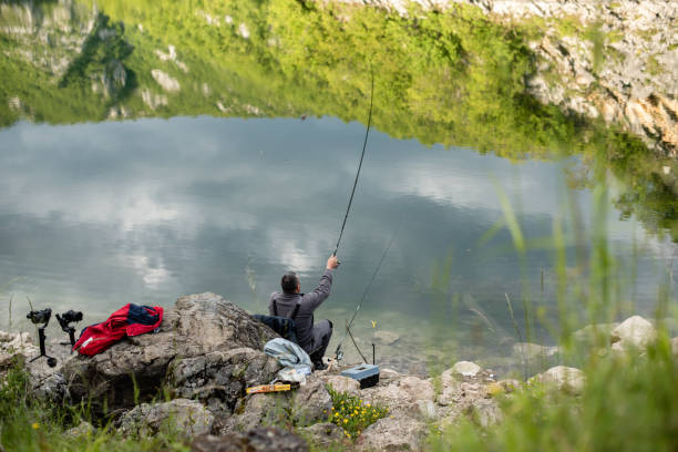 istock Fishermen is holding fishing rod 1262729524