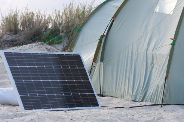 istock Solar Chargers for Camping. Camping elements equipment. Camping in the desert with solar panels for converting energy from the sun to electricity. 1262734051