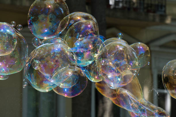 Realistic transparent colourful soap bubbles isolated on black background