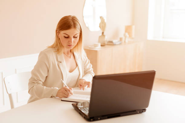 istock Beautiful businesswoman using laptop computer working from home 1262735149