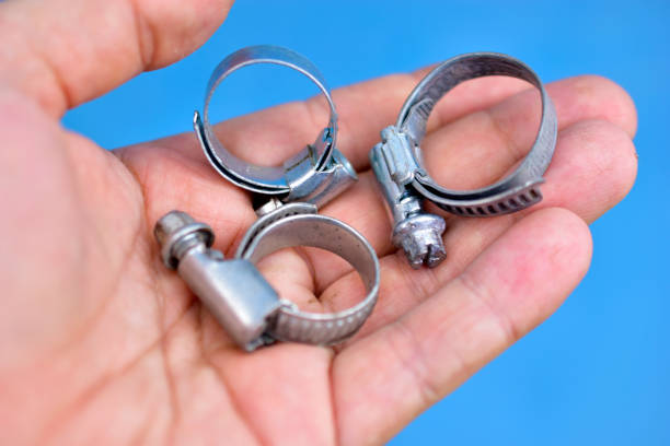 Iron clamps with thread in the hands of the master