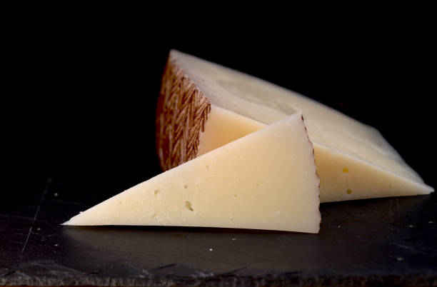 istock Hard cured sheep cheese from Spain on black slate board 1262739939