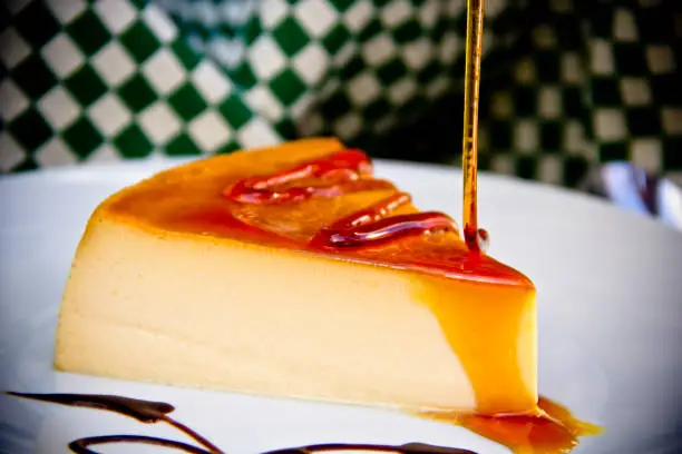 Creme caramel slice and golden syrup splash in a colorful background