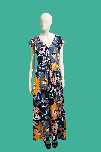 Full length female mannequin dressed in summer fashionable clothes, isolated on green background. No brand names or copyright objects.