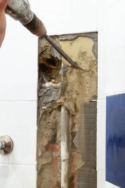 istock cleaning a water pipe in wall with rotary hammer 1262754519