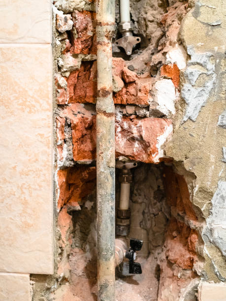 istock used water supply pipe in hole in brick wall 1262754537