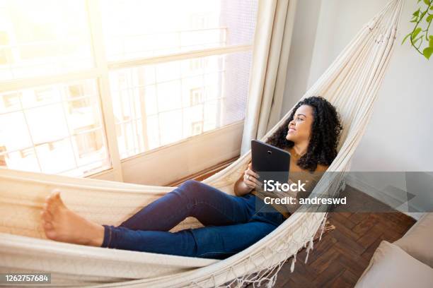 Woman Relaxing And Using Tablet Stock Photo - Download Image Now - Hammock, Relaxation, Laptop