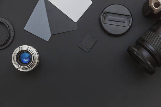 istock Photographer workplace with dslr camera system, camera cleaning kit, lens and camera accessory on dark black table background. Hobby travel photography concept Flat lay top view copy space 1262758897