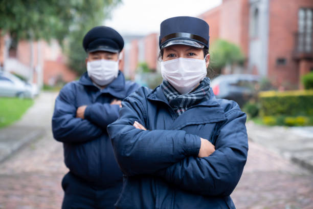 istock Security guards working at a gated community wearing a facemasks to avoid COVID-19 1262763598