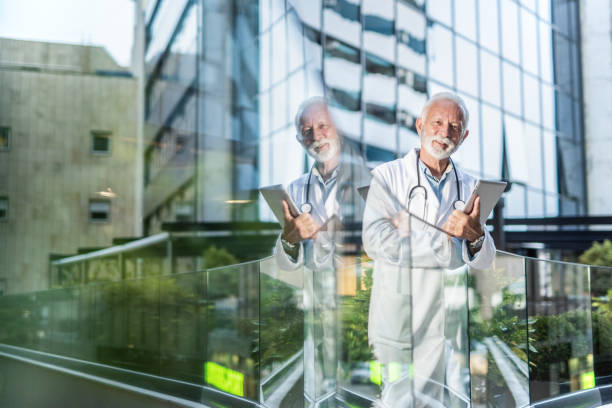 istock Happy senior doctor looking at camera. 1262765406