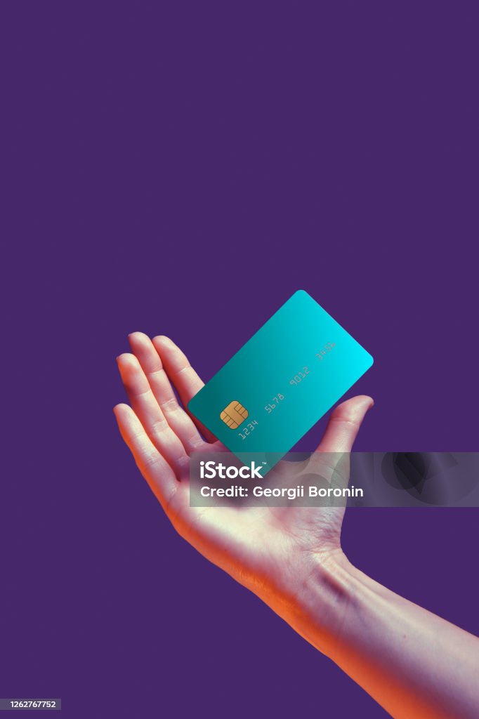 Close up female hand holds levitating template mockup Bank credit card with online service isolated on violet background Close up female hand holds levitating template mockup Bank credit card with online service isolated on violet background. High quality photo Credit Card Stock Photo