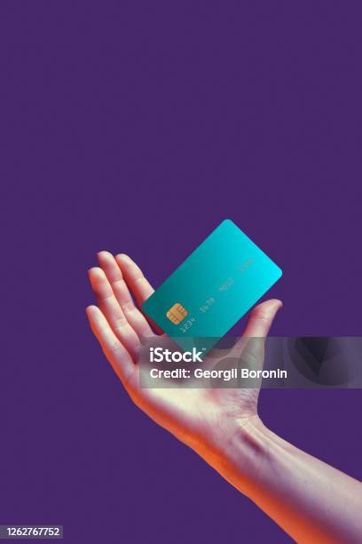 Close Up Female Hand Holds Levitating Template Mockup Bank Credit Card With Online Service Isolated On Violet Background Stock Photo - Download Image Now