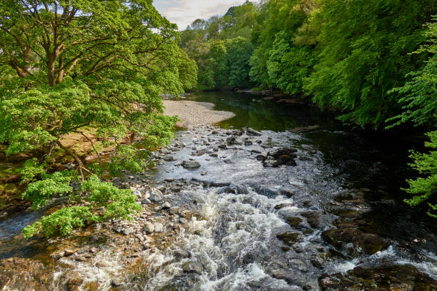 istock View of River rushing over shallow waterfall in Cumbria 1262769021