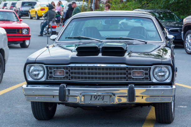 Dartmouth, Nova Scotia, Canada - July 30, 2015 : 1974 Plymouth Duster parked at Woodside Ferry Terminal parking lot during weekly summer A&W Cruise-in Dartmouth, Nova Scotia, Canada.