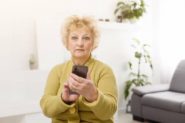 istock Upset elderly woman using touch screen mobile for taking selfie or making video call 1262769686