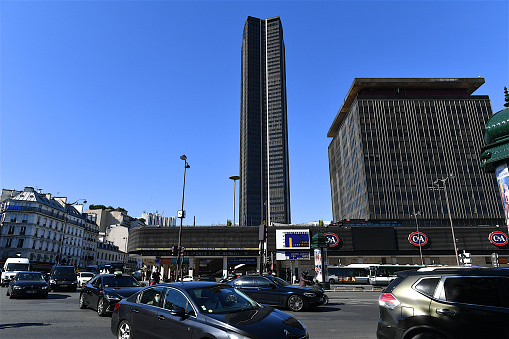 Paris, France-07 30 2020:Cars passing nearby the Montparnasse tower.The Tour Maine-Montparnasse, is a office skyscraper located in the Montparnasse area of Paris. Constructed from 1969 to 1973, it was the tallest skyscraper in France until 2011.The Maine Montparnasse shopping center.