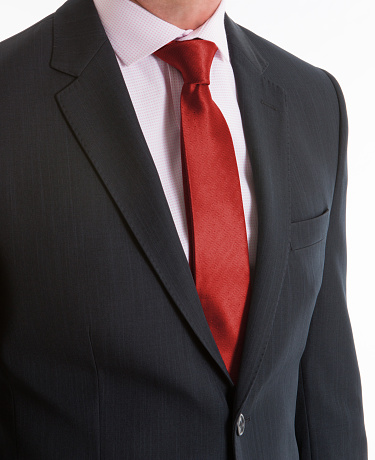 Close-up of pink necktie on gray pinstripe suit