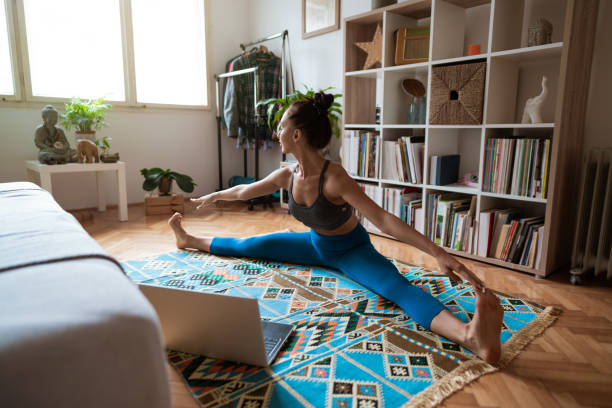 istock Young woman exercising online at home 1262774682