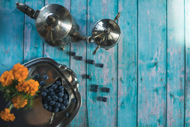 Afternoon tea and blueberries with some yellow flowers
