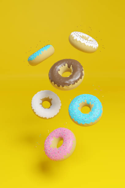 istock Donuts floating in the air isolated on a yellow background. 3d illustration. 1262777983