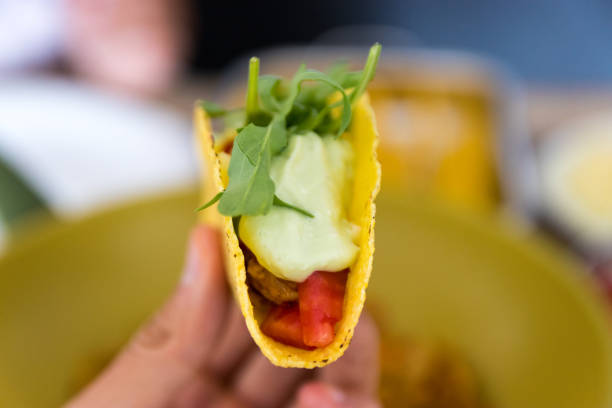 istock Man holding a taco closeup 1262781725