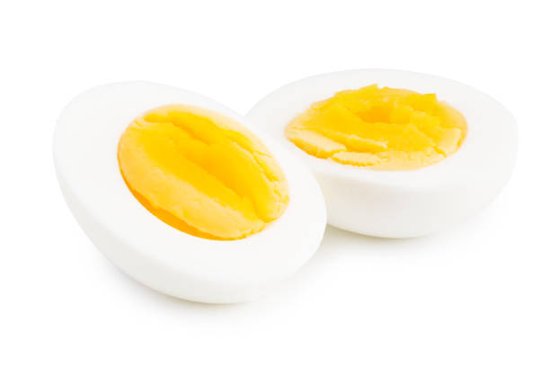 mezzo uovo sodo isolato su uno sfondo bianco - hard cooked egg foto e immagini stock