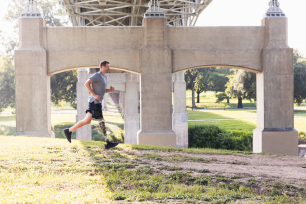 istock Male military veteran jogs under bridge at park 1262786558