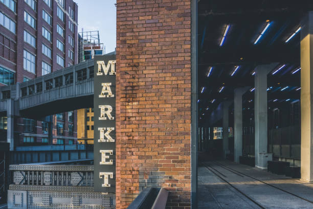 market neon sign seen from high line in chelsea. new york city. the market has lots of stores, restaurants and food markets. - chelsea new york imagens e fotografias de stock